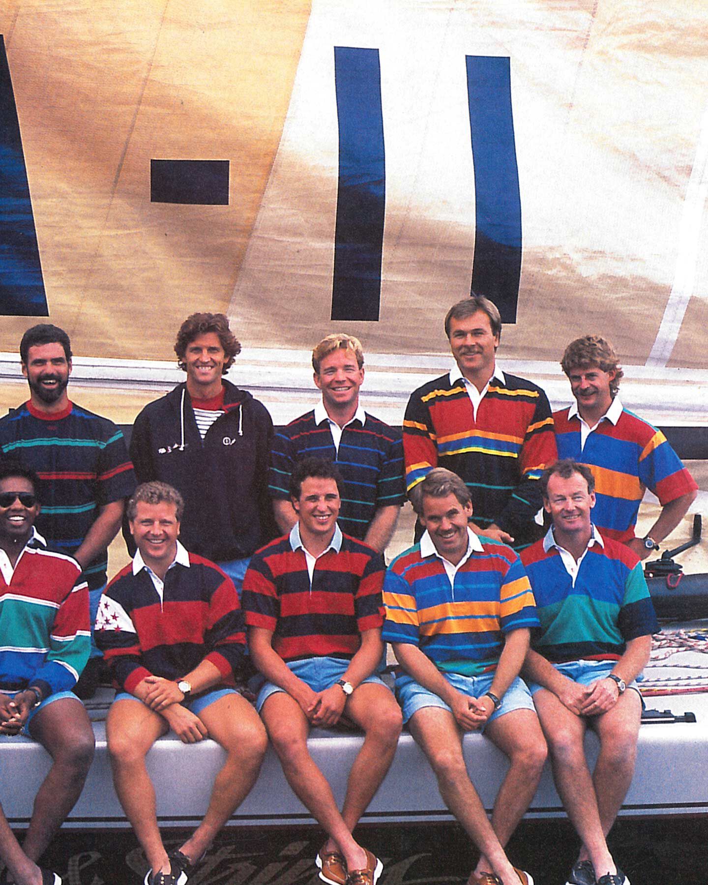 A group in striped Gant rugby shirts posed by a sail—nautical vibes meet '90s archive cool.