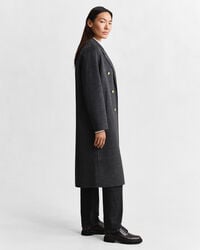 Ternet håndsyet frakke