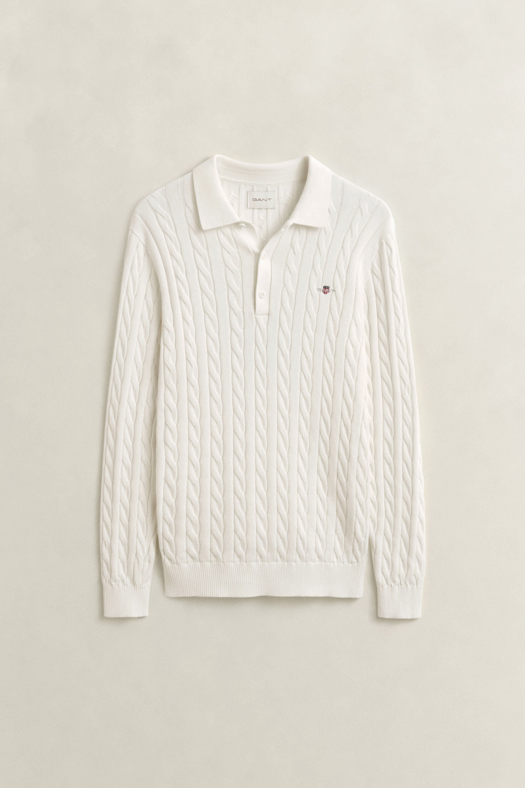 Polosweater i bomuld med kabelstrik