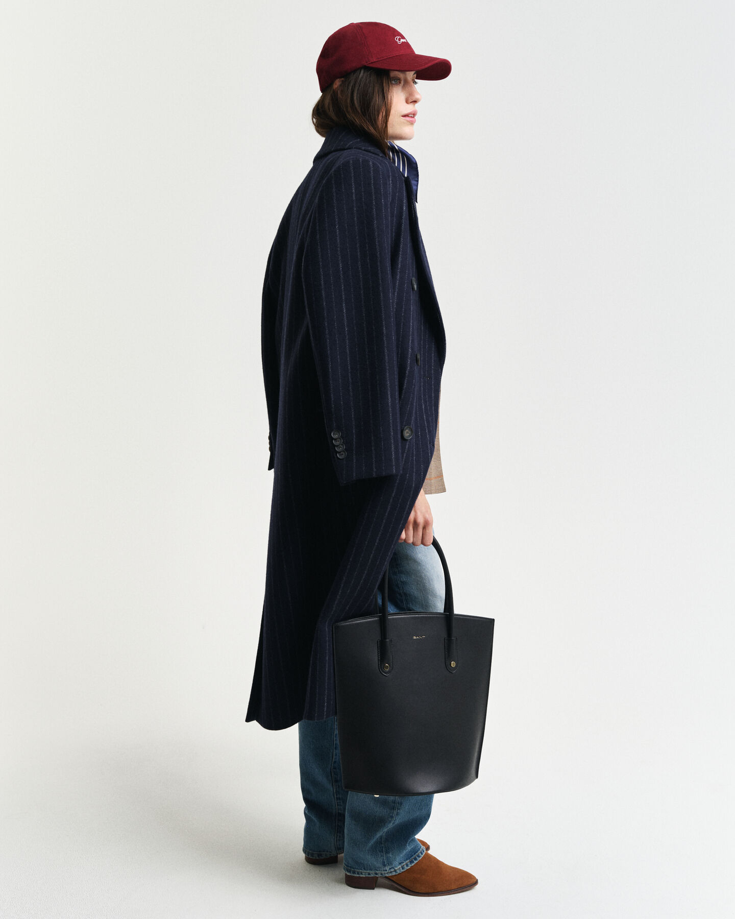 Posetaske i l&aelig;der med hanke foroven