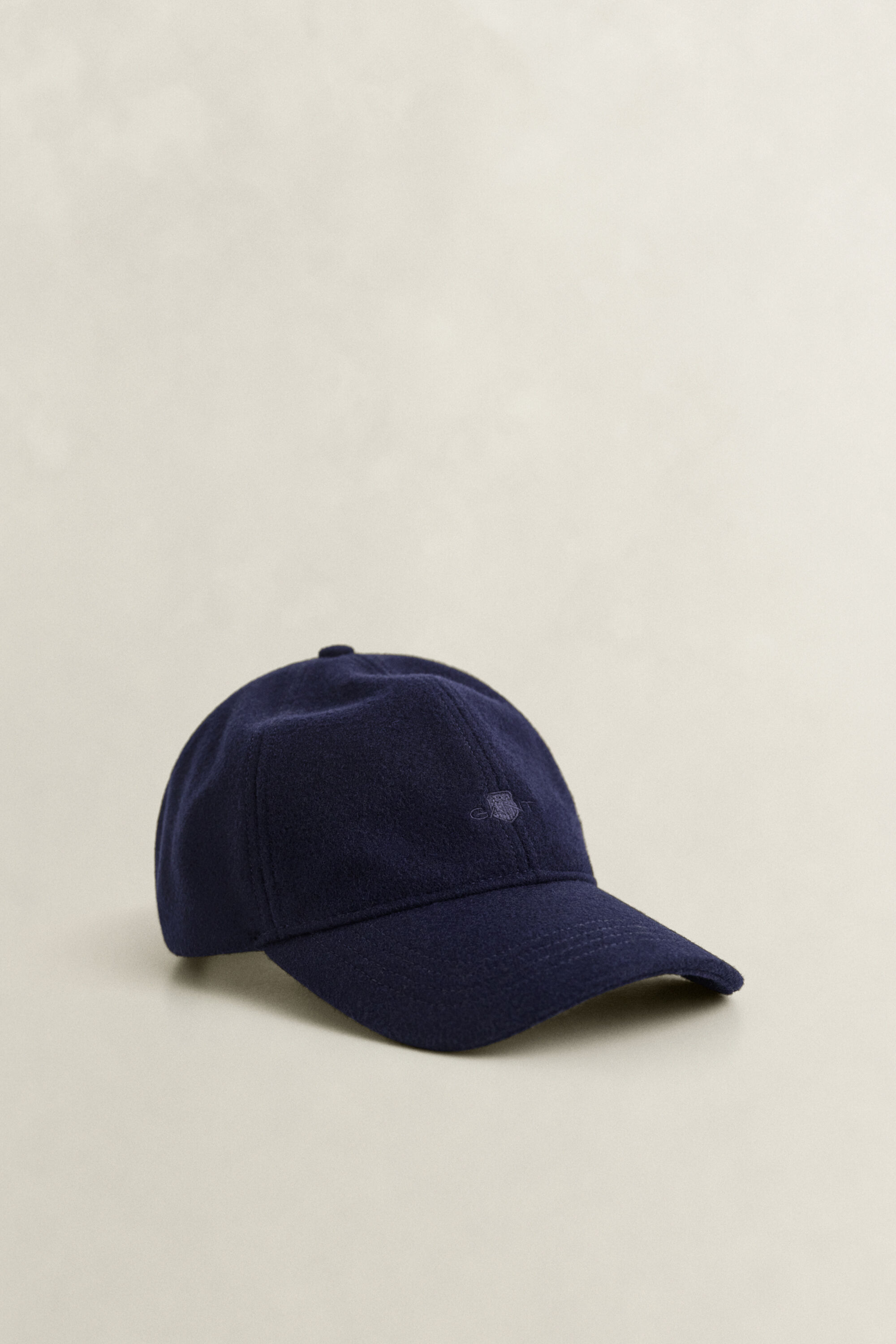 Melton cap med tonalt skjold