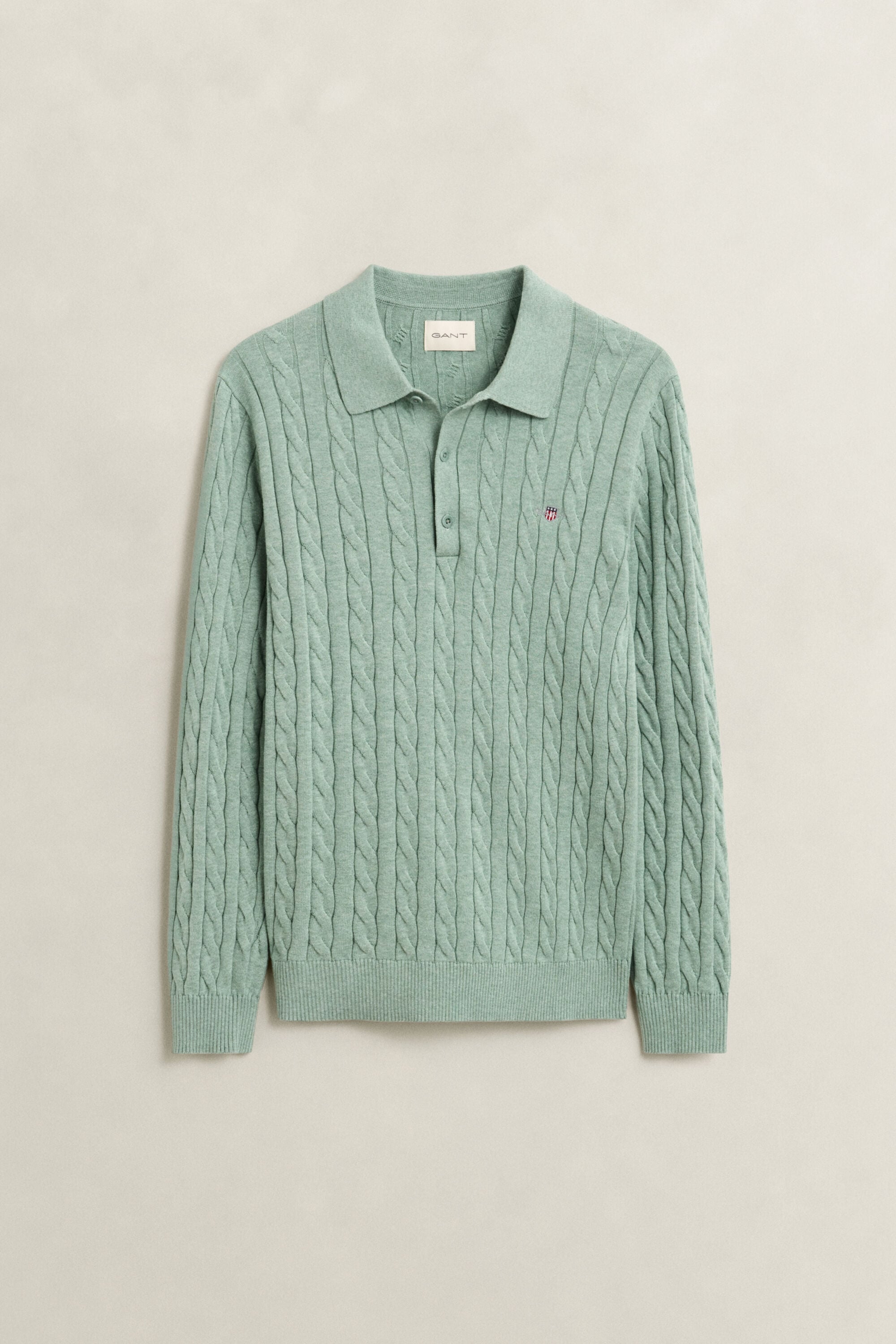 Polosweater i bomuld med kabelstrik