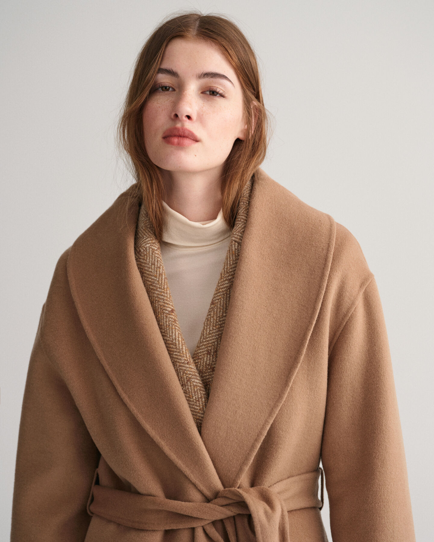 Håndsyet frakke med bælte